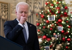 President Joe Biden coughs as he talks to reporters about the November Jobs Report from the State Dining Room of the White House in Washington, DC, on December 3, 2021. (Photo by ANDREW CABALLERO-REYNOLDS/AFP via Getty Images)