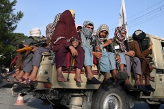 Taliban fighters patrol a street in Kabul over the summer. (Photo by Wakil Kohsar/AFP via Getty Images)