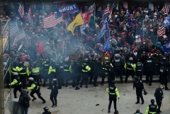 Police hold back Trump supporters as they gather outside the US Capitol on January 6, 2021. (Photo by OLIVIER DOULIERY/AFP via Getty Images)
