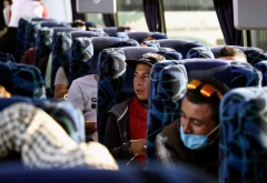 Migrants heading in a caravan towards the US wait on board a bus at the "House of the Pilgrim San Juan Diego" in Mexico City, on December 22, 2021. - Central American migrants will be transported to the cities of Monterrey, Juarez and Hermosillo. There, with the help of the authorities of the National Institute of Migration, they can continue their immigration procedures and can wait to enter to the United States. (Photo by ALFREDO ESTRELLA/AFP via Getty Images)