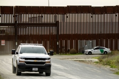 A US Border Patrol agents monitor from a vehicle a section of the US-Mexico border wall near Otay Mesa between San Diego and Tijuana on January 12, 2022 in San Diego County, California. (Photo by PATRICK T. FALLON/AFP via Getty Images)