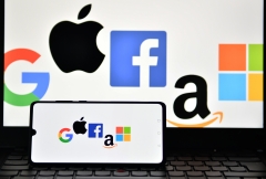 Featured are the logos of several Big Tech corporations. (Photo credit: JUSTIN TALLIS/AFP via Getty Images)