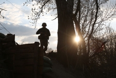 A Ukrainian soldiers patrols near the frontline with the Russian-backed separatist region of Luhansk, in eastern Ukraine. (Photo by STR/AFP via Getty Images)