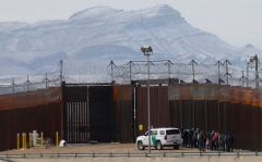 Border Patrol agents detain a group of illegal immigrants at the border wall in El Paso, Texas on February 3, 2022. (Photo by HERIKA MARTINEZ/AFP via Getty Images)