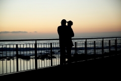 A father and son are seen taking in the sunrise. (Photo by Don Arnold/Getty Images)