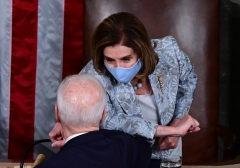 Speaker of the House Nancy Pelosi and President Joe Biden bump elbows after he addressed a joint session of Congress on April 28, 2021. (Photo by JIM WATSON/POOL/AFP via Getty Images)