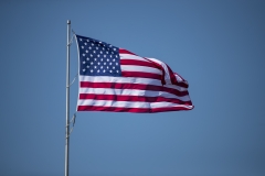 The American flag flaps in the wind. (Photo credit: Brett Carlsen/Getty Images)