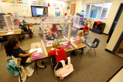 Kindergarten students do work while masked and behind shields. (Photo credit: GEORGE FREY/AFP via Getty Images)