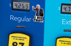 A gas pump displays current fuel prices, along with a sticker of Joe Biden, at a gas station in Arlington, Va. (Photo credit: SAUL LOEB/AFP via Getty Images)