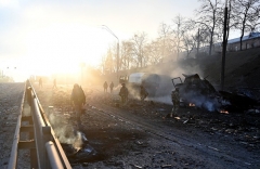 Ukrainian service members collect unexploded shells after a fighting with Russian raiding group in the Ukrainian capital of Kyiv on February 26, 2022, according to Ukrainian service personnel at the scene. (Photo by SERGEI SUPINSKY/AFP via Getty Images)