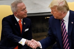 Rep. Jeff Van Drew of New Jersey switched from the Democratic Party to the Republican Party in 2019. He is seen here, shaking hands with then-President Donald Trump. (Photo by BRENDAN SMIALOWSKI/AFP via Getty Images)