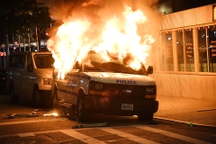 A New York Police Department vehicle burns in a riot after the death of George Floyd. (Photo credit: Kevin Mazur/Getty Images)
