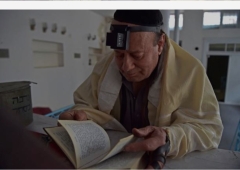 Zebulon Simentov, an Afghan Jew, looks at the Torah in a synagogue in Kabul on April 5, 2021.. (Photo by Wakil Kohsar/AFP via Getty Images)
