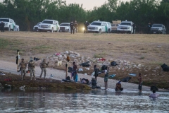 Haitians cross the Rio Grande towards the US under the watch of US Border Patrol, after Mexican police and National Institute of Migration officials blocked the Mexican side of the border at Parque Ecologico Braulio Fernandez in Ciudad Acuna, Coahuila state, Mexico on September 23, 2021. (Photo by PAUL RATJE/AFP via Getty Images)
