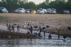 Haitians cross the Rio Grande towards the US under the watch of US Border Patrol, after Mexican police and National Institute of Migration officials blocked the Mexican side of the border at Parque Ecologico Braulio Fernandez in Ciudad Acuna, Coahuila state, Mexico on September 23, 2021.  (Photo by PAUL RATJE/AFP via Getty Images)