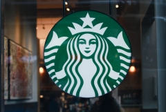 Featured is the outside of a Starbucks restaurant. (Photo credit: Kena Betancur/VIEWpress)