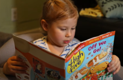 A child reads a Highlights magazine. (Photo credit: YouTube/Ideastream Public Media)