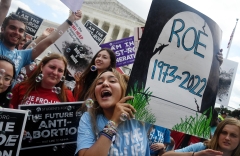 Pro-life protesters celebrate outside the Supreme Court after the overturn of Roe v. Wade. (Photo credit: OLIVIER DOULIERY/AFP via Getty Images)