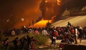 A caravan of more than a thousand people from Central and South America cross the Rio Grande into the El Paso, Texas on December 11, 2022. (Photo by HERIKA MARTINEZ/AFP via Getty Images)