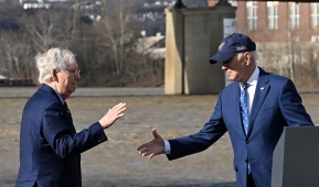 President Joe Biden extends a hand to Senate Minority Leader Mitch McConnell at an event promoting the bipartisan infrastructure law in Covington, Kentucky, on January 4, 2023. (Photo by JIM WATSON/AFP via Getty Images)