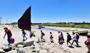 Scenes like this play out daily at the southwest border, this one in Yuma, Arizona, next to a gap in the border wall. (Photo by FREDERIC J. BROWN/AFP via Getty Images)